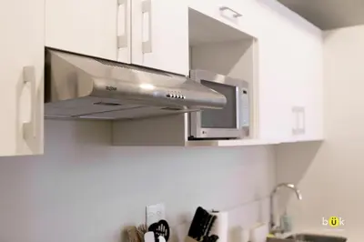 a kitchen with a stainless steel stove top oven at INSTAWORTHY CORNER VIEW 200Mbps in San José