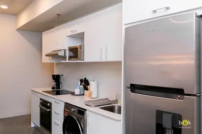 a kitchen with a stainless steel refrigerator and a dishwasher at INSTAWORTHY CORNER VIEW 200Mbps in San José