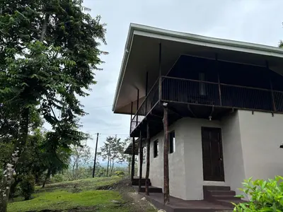 a building with a balcony on the side of it at Rancho and Modern Rustic House with a Valley View in Venecia