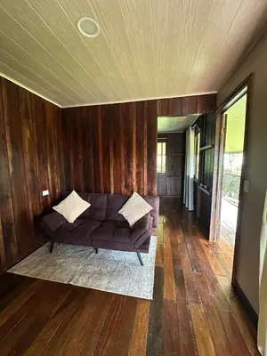 a living room with a couch and wooden walls at Rancho and Modern Rustic House with a Valley View in Venecia
