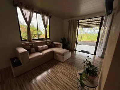 a living room with a couch and a large window at Rancho and Modern Rustic House with a Valley View in Venecia