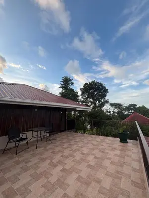 a patio with chairs and a table in front of a building at Rancho and Modern Rustic House with a Valley View in Venecia