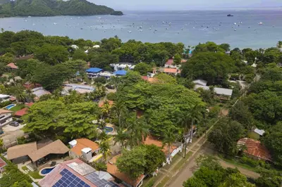 an aerial view of a town with trees and the water at Club Voca #2 in Coco