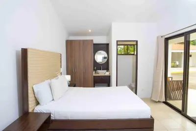 a bedroom with a white bed and a mirror at Club Voca #2 in Coco