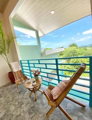 a room with two chairs and a table at Casa Nube, 3 mins to beaches in Sámara