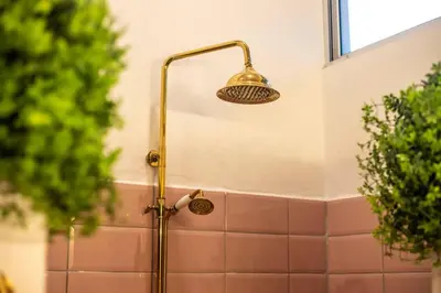 a shower with a shower head in a bathroom at Casa Nube, 3 mins to beaches in Sámara