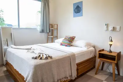 a bedroom with two beds and a window at Casa Nube, 3 mins to beaches in Sámara