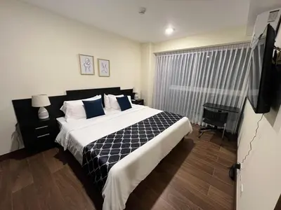 a bedroom with a large bed and a television at Luxury Escape 1 Bedroom & 1 Bathroom c404 Tly in San José