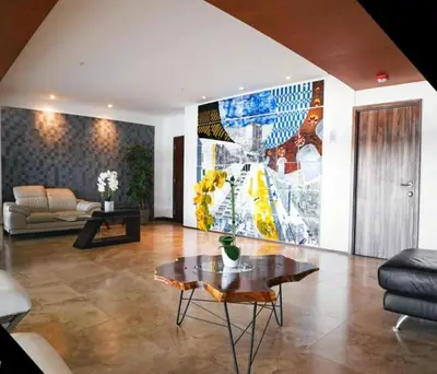 a living room with a large painting on the wall at Luxury Escape 1 Bedroom & 1 Bathroom c404 Tly in San José
