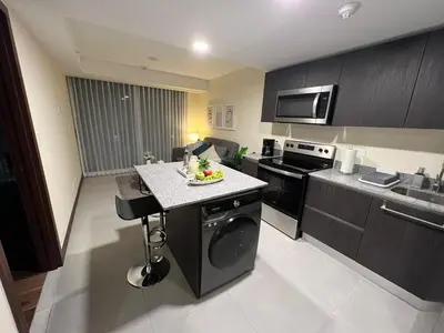 a kitchen with a island in the middle of it at Luxury Escape 1 Bedroom & 1 Bathroom c404 Tly in San José