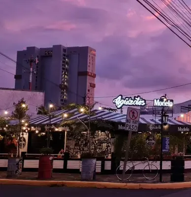 a bike parked in front of a restaurant at night at Evening Breeze in San José