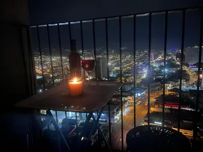 a table with a candle and a glass of wine at Evening Breeze in San José