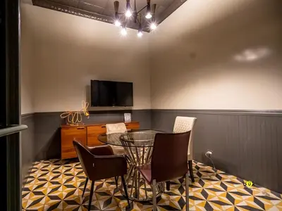 a dining room with a table and chairs and a tv at Evening Breeze in San José