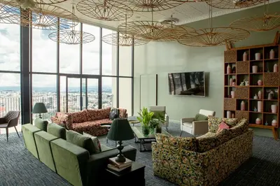 a living room with couches and chairs and windows at Evening Breeze in San José
