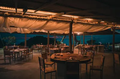 a restaurant with tables and chairs under a tent at Dar Lamia Boutique Hotel in Manuel Antonio