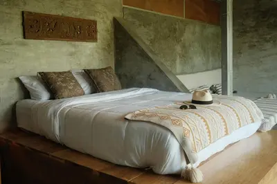a bedroom with a large bed with a hat on it at Dar Lamia Boutique Hotel in Manuel Antonio