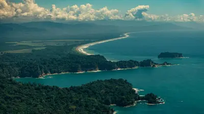 an island in the middle of a body of water at Dar Lamia Boutique Hotel in Manuel Antonio