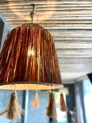 a brown lamp with tassels on a ceiling at Dar Lamia Boutique Hotel in Manuel Antonio