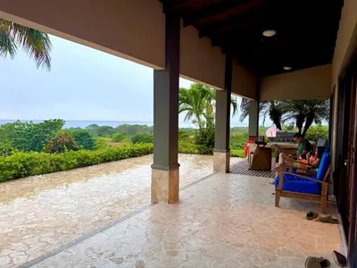 a porch of a house with people sitting in chairs at Villa Casa Modelo in Marbella