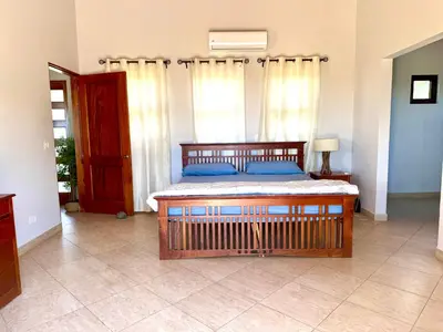 a bedroom with a bed with blue pillows at Villa Casa Modelo in Marbella