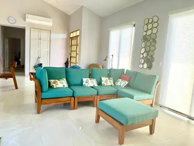 a living room with a blue couch and chairs at Villa Casa Modelo in Marbella