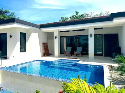 a house with a swimming pool in front of it at Villa Dorada 55 in Marbella