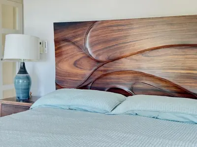 a bed with a wooden head board and a lamp at Villa Dorada 55 in Marbella