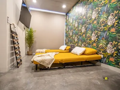two beds in a room with a colorful wall at Tropical Apartment URBN Escalante in San José