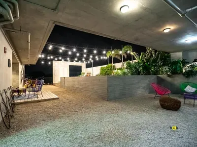 a room with chairs and a wall with lights at Tropical Apartment URBN Escalante in San José