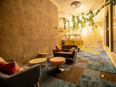 a living room with couches and tables and a yellow vehicle at Tropical Apartment URBN Escalante in San José