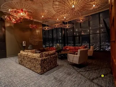 a living room with couches and a table and windows at Tropical Apartment URBN Escalante in San José