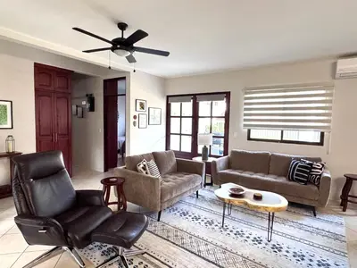 a living room with furniture and a ceiling fan at Casa Suerte in Coco