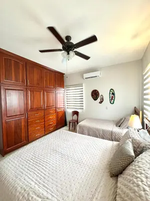 a bedroom with two beds and a ceiling fan at Casa Suerte in Coco
