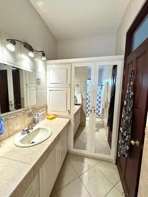 a bathroom with a sink and a large mirror at Casa Suerte in Coco