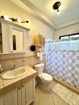 a bathroom with a sink and a toilet and a shower at Casa Suerte in Coco