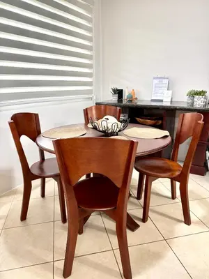 a dining room table with chairs and a table at Casa Suerte in Coco