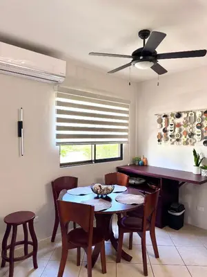 a dining room with a table and chairs and a ceiling fan at Casa Suerte in Coco