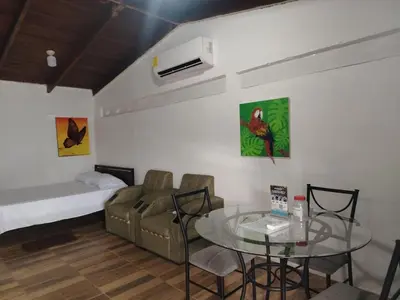 a room with a table and a couch and a bed at Apartamentos GoZu # 1 in Puerto Viejo
