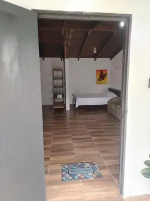 a room with a bed and a tile floor at Apartamentos GoZu # 1 in Puerto Viejo