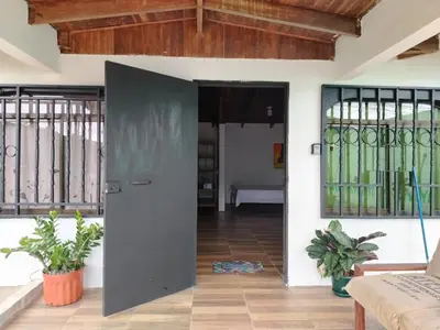 a pivot door in a living room with stained glass windows at Apartamentos GoZu # 1 in Puerto Viejo
