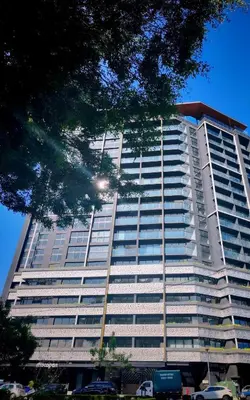 a tall building with cars parked in front of it at Beautiful view in San José