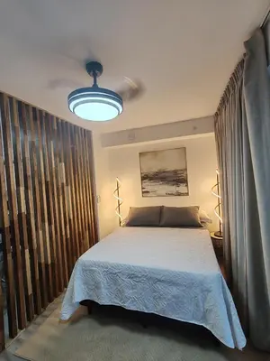a bedroom with a bed and a large window at Beautiful view in San José