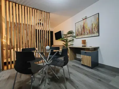 a room with a table and chairs and a desk at Beautiful view in San José