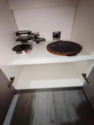 a shelf in a room with a toilet and pans at Balcony Sunset in San José