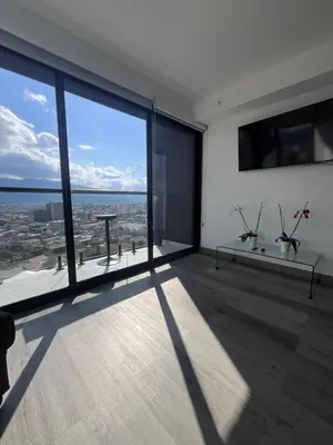 a room with a large window with a view of the city at Balcony Sunset in San José