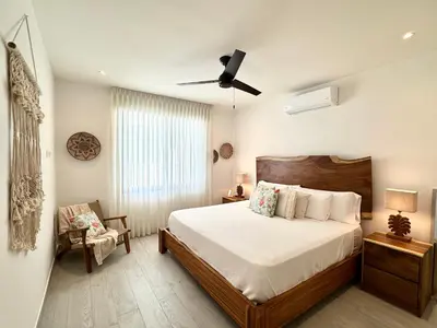 a bedroom with a bed and a ceiling fan at Grandy Oasis Villa with Private Pool in Coco
