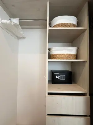a closet with a shelf with a clock and plates at Grandy Oasis Villa with Private Pool in Coco