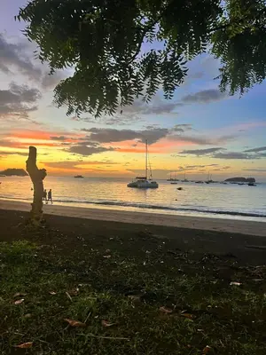 a person standing on the beach watching the sunset at Grandy Oasis Villa with Private Pool in Coco