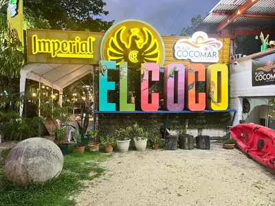 a sign for a restaurant with plants in front of it at Grandy Oasis Villa with Private Pool in Coco