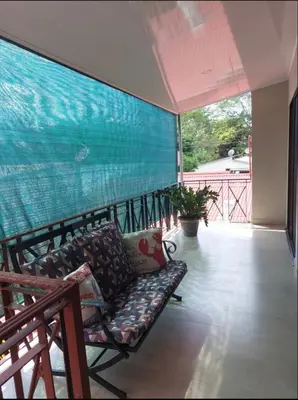 a couch on a balcony with a large mural at La Paz in Bahia